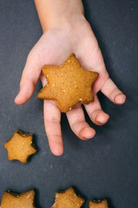 High angle view of hand holding cookies