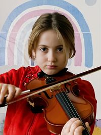 Portrait of young woman playing violin