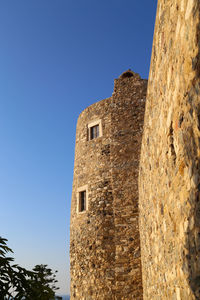 Low angle view of building against clear blue sky