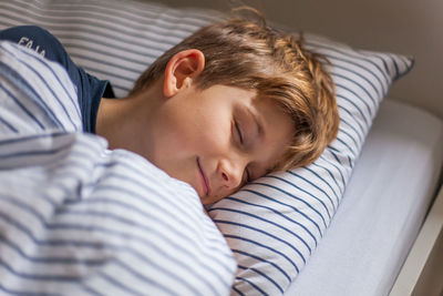 Portrait of boy sleeping in bed