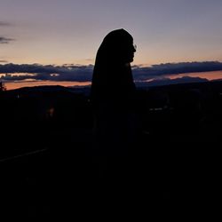 Silhouette man against sky during sunset