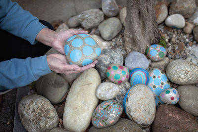 Low section of person standing on pebbles