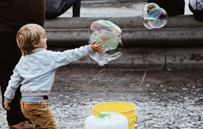 High angle view of people holding bubbles in water