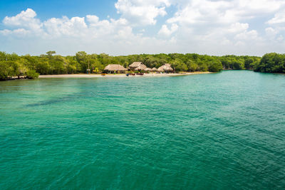 Scenic view of turquoise colored sea against sky