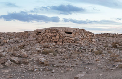 Rock formations on landscape against sky