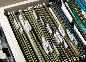 High angle view of documents arranged in drawer