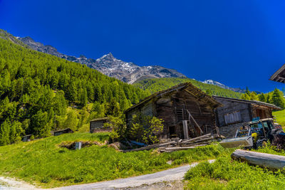 Scenic view of trees and houses against sky