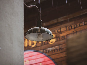 Close-up of pendant light hanging on wall