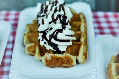 Close-up of whipped cream on waffles