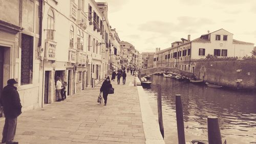 Rear view of people walking in city