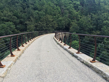 Footbridge amidst trees in forest