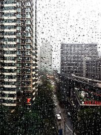Buildings seen through wet window during rainy season