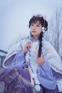 A girl in hanfu in the snow