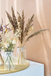 Dried flowers bouquets in plastic bottles to reduce waste. aesthetic, eco friendly home decor.