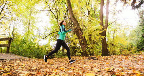 Woman running in forest