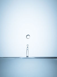 Close-up of water splashing against blue background