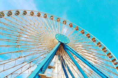 Low angle view of ferris wheel against blue sky