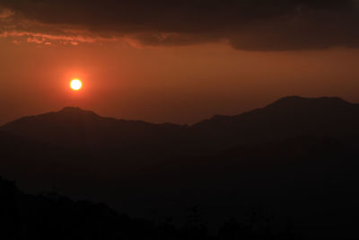 Scenic view of silhouette mountains against sky at sunset