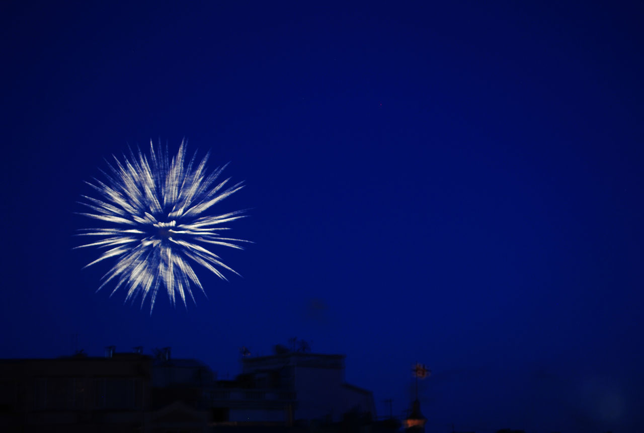 LOW ANGLE VIEW OF FIREWORK DISPLAY AGAINST SKY AT NIGHT