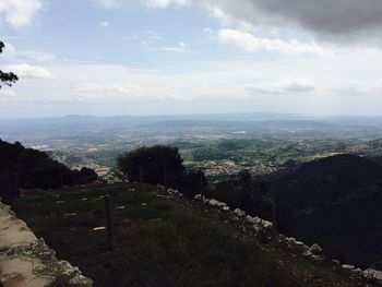 View of cityscape against cloudy sky