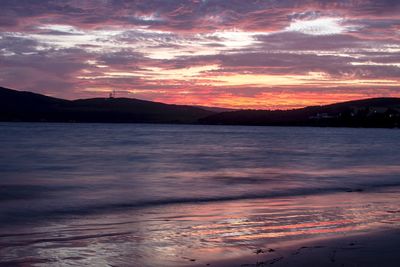 Scenic view of sea against romantic sky at sunset