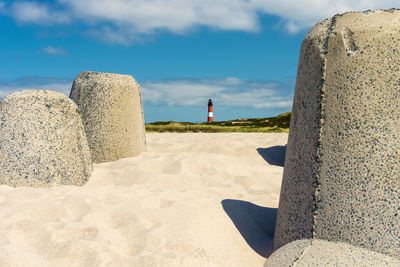 Rocks on beach against sky