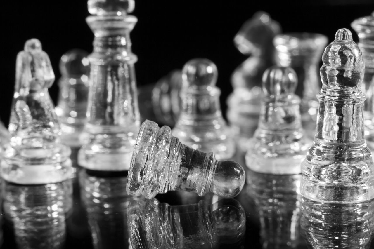 CLOSE-UP OF CHESS PIECES ON COUNTER