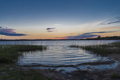 Scenic view of lake against sky during sunset