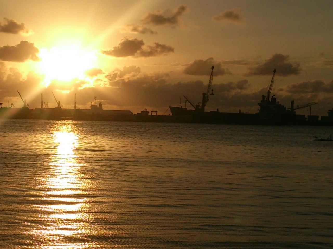 sunset, sun, water, waterfront, sky, silhouette, orange color, sea, reflection, sunlight, scenics, nautical vessel, tranquil scene, rippled, beauty in nature, tranquility, nature, transportation, river, harbor