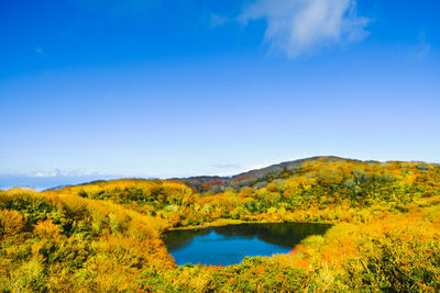 Scenic view of lake against blue sky during autumn