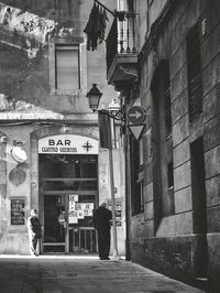 Man walking in front of building