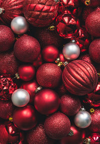 Close up of a variety of red and white christmas ball ornaments.