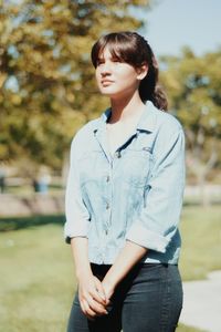 Portrait of young woman standing on ground