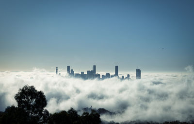 Panoramic view of fog and buildings against sky