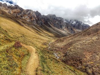 Scenic view of mountain against cloudy sky