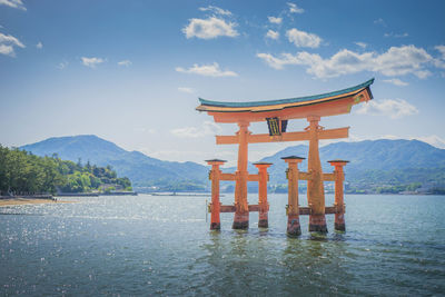Lifeguard hut in lake against sky