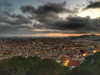 High angle shot of townscape against sky at dusk