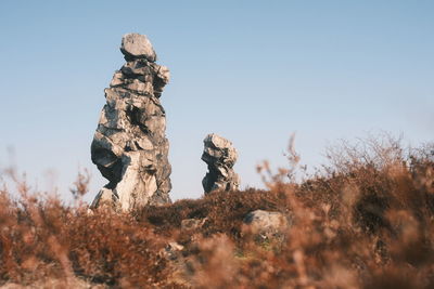 Low angle view of rock against clear sky