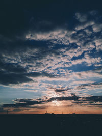 Silhouette of landscape against cloudy sky
