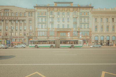 Cars on street against buildings in city