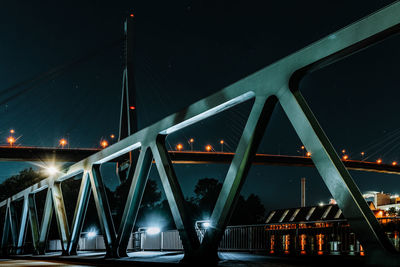 Illuminated bridge against sky at night