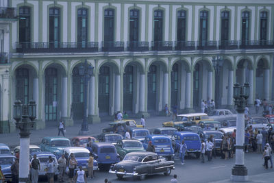 Cars on street by buildings in city