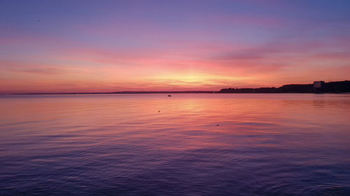 Scenic view of sea against romantic sky at sunset
