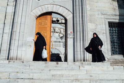 Woman standing in front of church