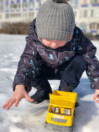 Rear view of boy wearing hat during winter