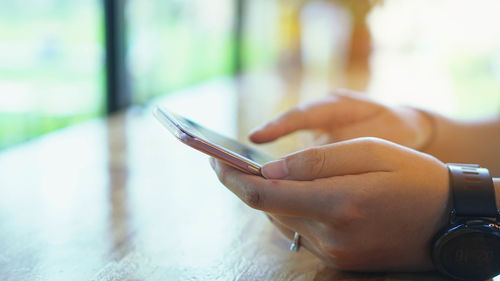 Close-up of hand using mobile phone