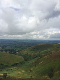 Countryside landscape against cloudy sky