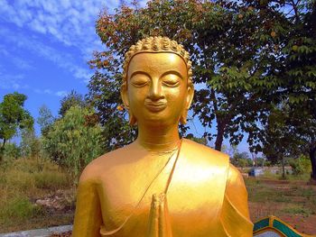 Statue of buddha against trees