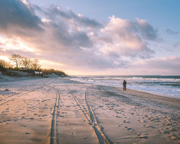 Scenic view of beach against sky during sunset