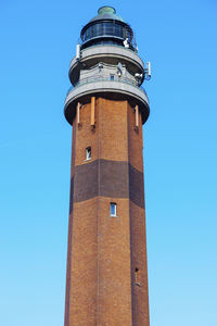 Low angle view of lighthouse against clear blue sky